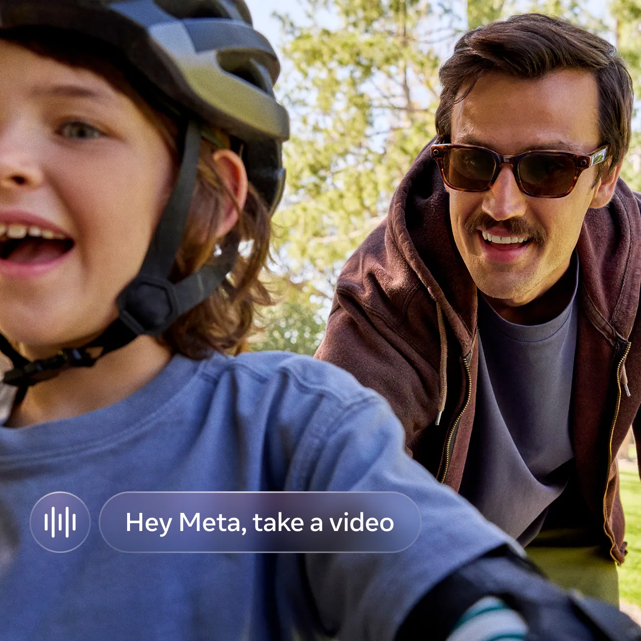 A man wearing LEGALISS glasses rides a bike alongside a smiling young child in a helmet on a tree-lined trail.